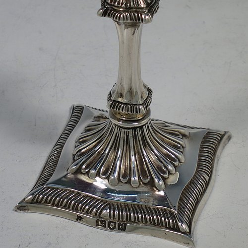 A very pretty Antique Victorian cast sterling silver taper-stick, having shaped gadroon borders, and hand-chased fluted decoration, with a removable nozzle. All made by Turner Bradbury of London in 1896. The dimensions of this fine hand-made antique silver taper-stick are height 12 cms (4.75 inches), and it weighs approx. 146g (4.7 troy ounces).