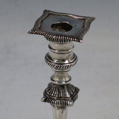A very pretty Antique Victorian cast sterling silver taper-stick, having shaped gadroon borders, and hand-chased fluted decoration, with a removable nozzle. All made by Turner Bradbury of London in 1896. The dimensions of this fine hand-made antique silver taper-stick are height 12 cms (4.75 inches), and it weighs approx. 146g (4.7 troy ounces).