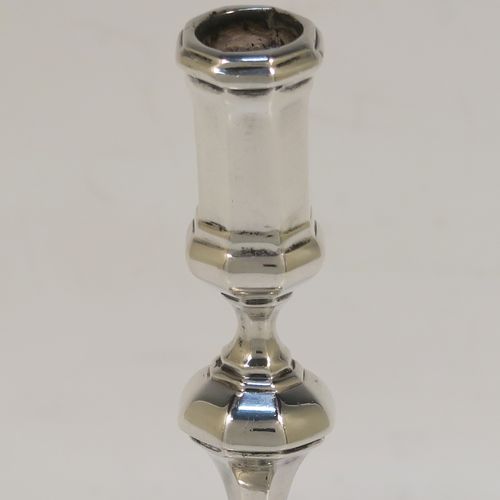 A very elegant cast Sterling Silver pair of taper-sticks, in a Queen Anne or George I style, having a baluster body with hand-chased octagonal and reeded decoration. These handsome silver tapersticks were made by Turner Bradbury of London in 1897. The dimensions of these fine hand-made antique silver taper-sticks are height 11.5 cms (4.5 inches), width across base 7.5 cms (3 inches), and they weigh a total of approx. 214g (6.9 troy ounces). Please note that this taper-stick is cast and not filled, so the whole weight is silver.