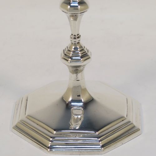 A very elegant cast Sterling Silver pair of taper-sticks, in a Queen Anne or George I style, having a baluster body with hand-chased octagonal and reeded decoration. These handsome silver tapersticks were made by Turner Bradbury of London in 1897. The dimensions of these fine hand-made antique silver taper-sticks are height 11.5 cms (4.5 inches), width across base 7.5 cms (3 inches), and they weigh a total of approx. 214g (6.9 troy ounces). Please note that this taper-stick is cast and not filled, so the whole weight is silver.