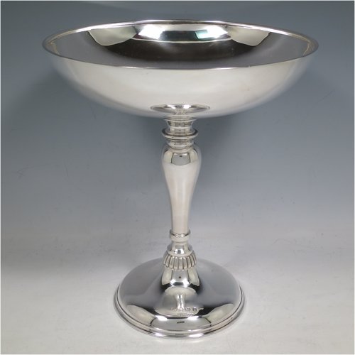 An Antique Edwardian Sterling Silver tazza dish, having a plain round bowl body, sitting on a pedestal foot with matching decoration and a small band of fluting. Made in Birmingham in 1909. The dimensions of this fine hand-made antique silver tazza dish are height 23 cms (9 inches), diameter 20 cms (8 inches), and it weighs approx. 435g (14 troy ounces).   