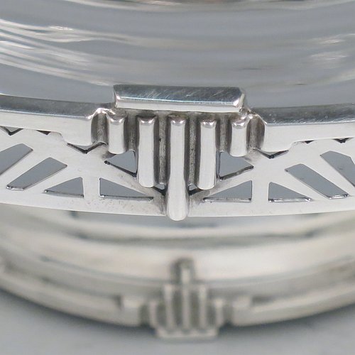 A Sterling Silver Art Deco tazza dish, having a round plain body, with a hand-pierced gallery border and applied Art Deco motifs, and all sitting on a matching pedestal foot. Made by Walker & Hall of Sheffield in 1933. The dimensions of this fine hand-made silver Art Deco tazza dish are height 10 cms (4 inches), diameter 25.5 cms (10 inches), and it weighs approx. 530g (17 troy ounces).