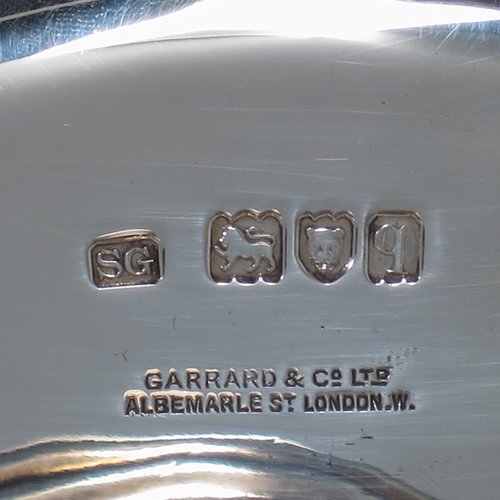 An Antique Sterling Silver very heavy tazza cake dish, having a plain hexagonal body, with a gadroon border, and sitting on a pedestal foot with applied cut-card work and hand-chased fluting. Made by Sebastian Garrard of London in 1911. The dimensions of this fine hand-made antique silver tazza dish are height 8 cms (3 inches), width of plate 31 cms (12.25 inches), and the weight is approx. 1,425g (46 troy ounces).