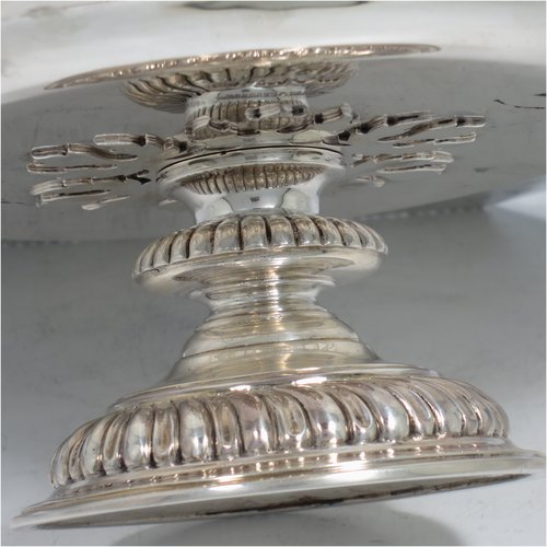 An Antique Sterling Silver very heavy tazza cake dish, having a plain hexagonal body, with a gadroon border, and sitting on a pedestal foot with applied cut-card work and hand-chased fluting. Made by Sebastian Garrard of London in 1911. The dimensions of this fine hand-made antique silver tazza dish are height 8 cms (3 inches), width of plate 31 cms (12.25 inches), and the weight is approx. 1,425g (46 troy ounces).