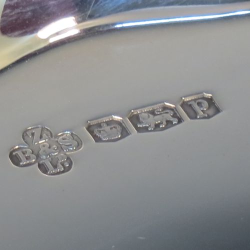 A handsome and heavy Sterling Silver tazza dish, having a round body with an applied and shaped reeded border, and sitting on a round stepped pedestal foot. Made by Z. Barraclough and Sons Ltd., of Sheffield in 1932. The dimensions of this fine hand-made silver tazza dish are height 8 cms (3 inches), diameter 25.5 cms (10 inches), and it weighs approx. 780g (25 troy ounces).