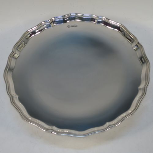 A handsome and heavy Sterling Silver tazza dish, having a round body with an applied and shaped reeded border, and sitting on a round stepped pedestal foot. Made by Z. Barraclough and Sons Ltd., of Sheffield in 1932. The dimensions of this fine hand-made silver tazza dish are height 8 cms (3 inches), diameter 25.5 cms (10 inches), and it weighs approx. 780g (25 troy ounces).
