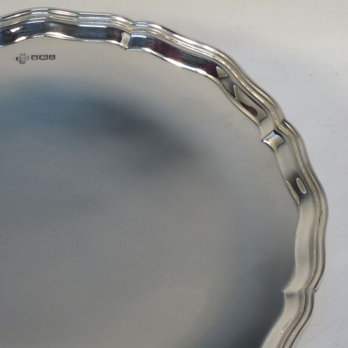 A handsome and heavy Sterling Silver tazza dish, having a round body with an applied and shaped reeded border, and sitting on a round stepped pedestal foot. Made by Z. Barraclough and Sons Ltd., of Sheffield in 1932. The dimensions of this fine hand-made silver tazza dish are height 8 cms (3 inches), diameter 25.5 cms (10 inches), and it weighs approx. 780g (25 troy ounces).