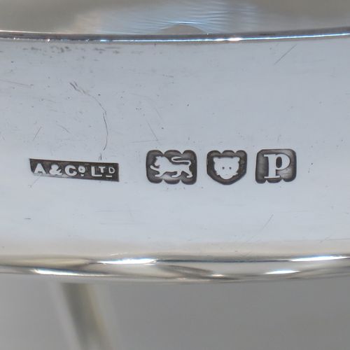 A pretty Art Nouveau style Antique Edwardian Sterling Silver tazza dish or bowl, having a plain round bowl body, sitting on a plain round pedestal foot with three scrolled supports. Made by Aspreys
and Co. Ltd., of London in 1910. The dimensions of this fine hand-made antique silver tazza bowl or dish are height 17.5 cms (7 inches), diameter of bowl 23 cms (9 inches), and it weighs approx. 719g (23 troy ounces).