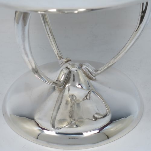 A pretty Art Nouveau style Antique Edwardian Sterling Silver tazza dish or bowl, having a plain round bowl body, sitting on a plain round pedestal foot with three scrolled supports. Made by Aspreys
and Co. Ltd., of London in 1910. The dimensions of this fine hand-made antique silver tazza bowl or dish are height 17.5 cms (7 inches), diameter of bowl 23 cms (9 inches), and it weighs approx. 719g (23 troy ounces).