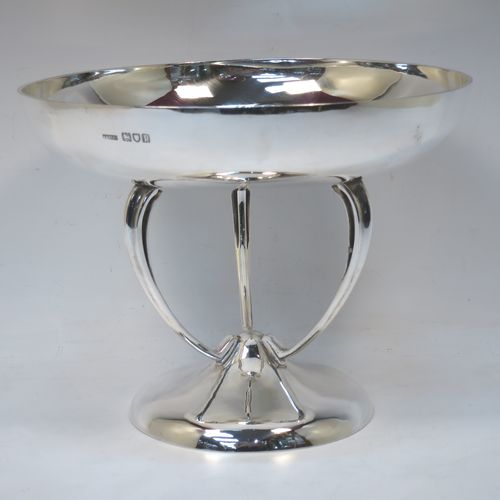 A pretty Art Nouveau style Antique Edwardian Sterling Silver tazza dish or bowl, having a plain round bowl body, sitting on a plain round pedestal foot with three scrolled supports. Made by Aspreys
and Co. Ltd., of London in 1910. The dimensions of this fine hand-made antique silver tazza bowl or dish are height 17.5 cms (7 inches), diameter of bowl 23 cms (9 inches), and it weighs approx. 719g (23 troy ounces).