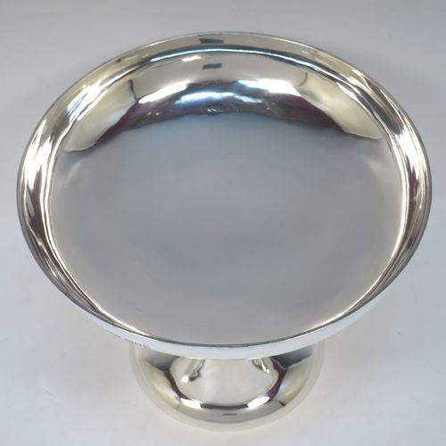 A pretty Art Nouveau style Antique Edwardian Sterling Silver tazza dish or bowl, having a plain round bowl body, sitting on a plain round pedestal foot with three scrolled supports. Made by Aspreys
and Co. Ltd., of London in 1910. The dimensions of this fine hand-made antique silver tazza bowl or dish are height 17.5 cms (7 inches), diameter of bowl 23 cms (9 inches), and it weighs approx. 719g (23 troy ounces).