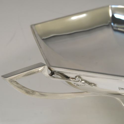 A very handsome Sterling Silver tazza dish or bowl, having a plain hexagonal paneled body, with two cast side-handles having scroll-leaf terminals, and sitting on a matching pedestal foot. This beautiful tazza dish was made by Walker and Hall of Sheffield in 1927. The dimensions of this fine hand-made silver tazza bowl or dish are height 16 cms (6.3 inches), width across handles 31 cms (12.25 inches), and it weighs approx. 638g (20.6 troy ounces).