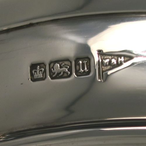 A very handsome Antique Sterling Silver Tazza dish, having a plain round body, with applied reeded borders and two scroll side handles, all raised above and sitting on a plain round pedestal foot. This elegant silver dish was made by Walker and Hall of Sheffield in 1912. The dimensions of this fine hand-made antique silver Tazza dish are height 16.5 cms (6.5 inches), diameter 20 cms (8 inches), and it weighs approx. 464g (15 troy ounces).