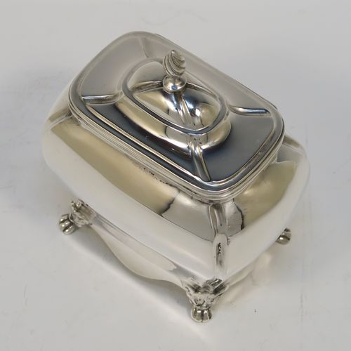 A very handsome Antique Sterling Silver tea caddy box in a Bon-bonier style, having a rectangular bellied body with hand-chased fluted corners, a hinged domed lid with a cast swirl finial, a gold-gilt interior, and all sitting on four cast lions-paw feet. This elegant antique silver tea caddy box was made by S. Blanckensee and Sons of Chester in 1921. The dimensions of this fine hand-made antique silver tea caddy box are height 11 cms (4.3 inches), depth 6.5 cms (2.6 inches), width 9.5 cms (3.75 inches), and it weighs approx. 186g (6 troy ounces).