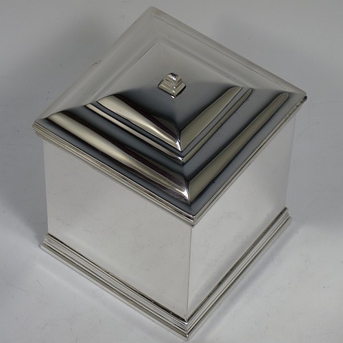 An Antique Edwardian Sterling Silver tea caddy box, having a plain square shaped body with plain straight sides and applied reeded top and bottom borders, a hinged stepped lid with a finial, and all sitting on a flat base. Made by Holland, Aldwinckle, and Slater of London in 1910. The dimensions of this fine hand-made antique silver tea caddy box are height 11 cms (4.25 inches), width 8 cms (3 inches) square, and it weighs approx. 417g (13.5 troy ounces).    