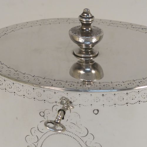 A very handsome Antique Georgian Sterling Silver tea caddy box, having an oval straight-sided body with an upper and lower band of hand-engraved floral decoration, a cast urn-shaped finial attached to a lid with flat hidden hinge and matching decoration, with original lock and key. This elegant antique silver tea caddy box was made by Joseph Preedy of London in 1778. The dimensions of this fine hand-made antique tea caddy box are height 11 cms (4.25 inches), length 12 cms (4.75 inches), width 9 cms (3.5 inches), and it weighs approx. 350g (11.3 troy ounces).