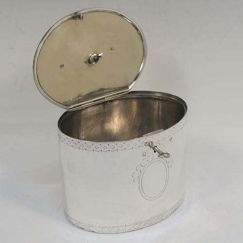 A very handsome Antique Georgian Sterling Silver tea caddy box, having an oval straight-sided body with an upper and lower band of hand-engraved floral decoration, a cast urn-shaped finial attached to a lid with flat hidden hinge and matching decoration, with original lock and key. This elegant antique silver tea caddy box was made by Joseph Preedy of London in 1778. The dimensions of this fine hand-made antique tea caddy box are height 11 cms (4.25 inches), length 12 cms (4.75 inches), width 9 cms (3.5 inches), and it weighs approx. 350g (11.3 troy ounces).
