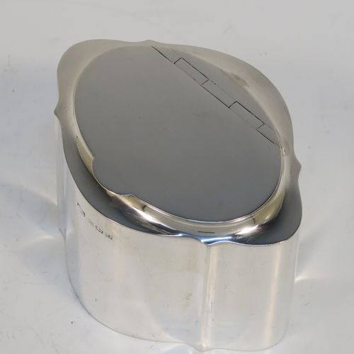 A very handsome Antique Sterling Silver tea caddy box, having a very plain shaped oval body with straight sides, an invisibly flat hinged plain lid with thumb-piece, a gold-gilt interior, and sitting on a flat base. This elegant antique silver tea caddy box was made by Levi and Salaman of Birmingham in 1919. The dimensions of this fine hand-made antique silver tea caddy box are height 7 cms (2.75 inches), length 9.5 cms (3.75 inches), depth 7 cms (2.75 inches), and it weighs approx. 143g (4.6 troy ounces).