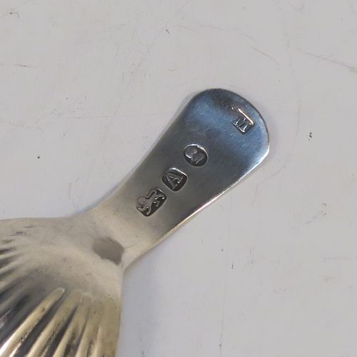 A very handsome Antique Georgian Sterling Silver tea caddy spoon, having a hand-engraved curved handle, and a hand-chased shell style oval bowl. This elegant antique silver tea caddy spoon was made in London in 1796. The dimensions of this fine hand-made antique silver tea caddy spoon are length 7 cms (2.75 inches), width 3.5 cms (1.3 inches), and it weighs approx. 6g (0.2 troy ounces).