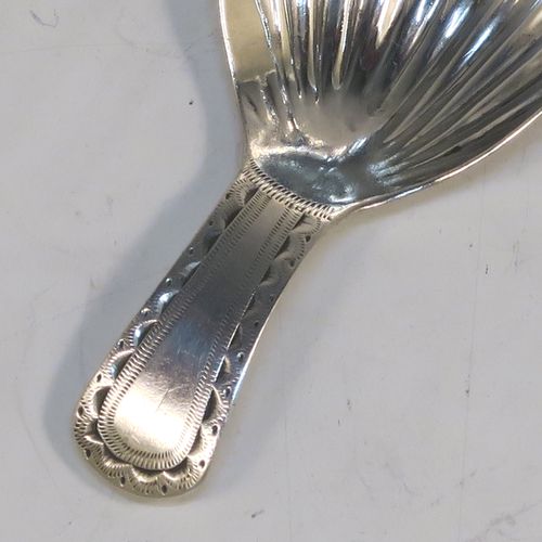 A very handsome Antique Georgian Sterling Silver tea caddy spoon, having a hand-engraved curved handle, and a hand-chased shell style oval bowl. This elegant antique silver tea caddy spoon was made in London in 1796. The dimensions of this fine hand-made antique silver tea caddy spoon are length 7 cms (2.75 inches), width 3.5 cms (1.3 inches), and it weighs approx. 6g (0.2 troy ounces).