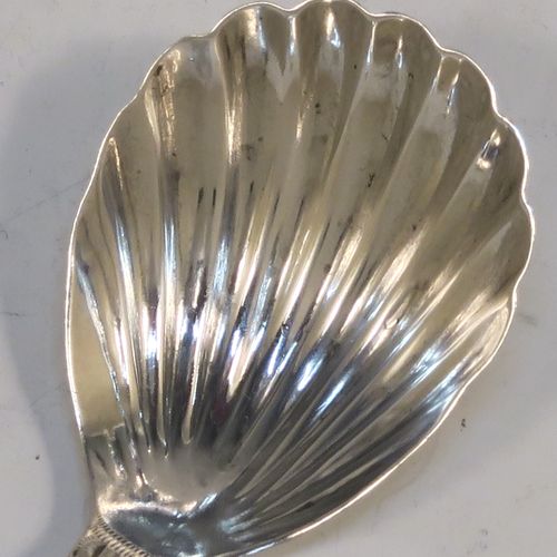 A very handsome Antique Georgian Sterling Silver tea caddy spoon, having a hand-engraved curved handle, and a hand-chased shell style oval bowl. This elegant antique silver tea caddy spoon was made in London in 1796. The dimensions of this fine hand-made antique silver tea caddy spoon are length 7 cms (2.75 inches), width 3.5 cms (1.3 inches), and it weighs approx. 6g (0.2 troy ounces).