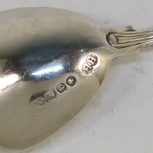 A pretty Antique Victorian Sterling Silver tea caddy spoon, having a double-struck fancy pattern handle, and a plain oval bowl. This beautiful antique silver tea caddy spoon was made by Henry Holland of London in 1860. The dimensions of this fine hand-made antique silver tea caddy spoon are length 10 cms (4 inches), width across bowl 4 cms (1.5 inches), and it weighs approx. 20g (0.65 troy ounces).