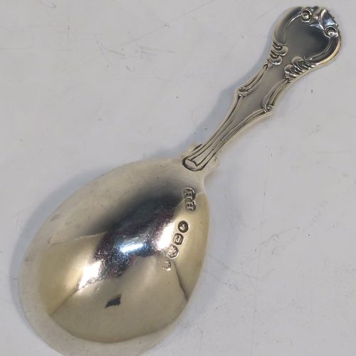 A pretty Antique Victorian Sterling Silver tea caddy spoon, having a double-struck fancy pattern handle, and a plain oval bowl. This beautiful antique silver tea caddy spoon was made by Henry Holland of London in 1860. The dimensions of this fine hand-made antique silver tea caddy spoon are length 10 cms (4 inches), width across bowl 4 cms (1.5 inches), and it weighs approx. 20g (0.65 troy ounces).