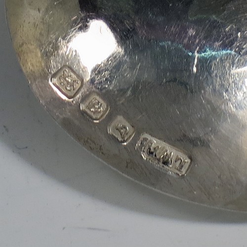 An Arts and Crafts Sterling Silver tea caddy spoon, having a cast twisted ribbon style handle with two applied beads between the turned-over ribbon ends, and a plenished hand-hammered round bowl. Made by Leonard William Burt of London in 1957. The dimensions of this fine hand-made Arts and Crafts style silver tea caddy spoon are length 9 cms (3.5 inches), width across bowl 4 cms (1.5 inches), and it weighs approx. 24g (0.75 troy ounces).