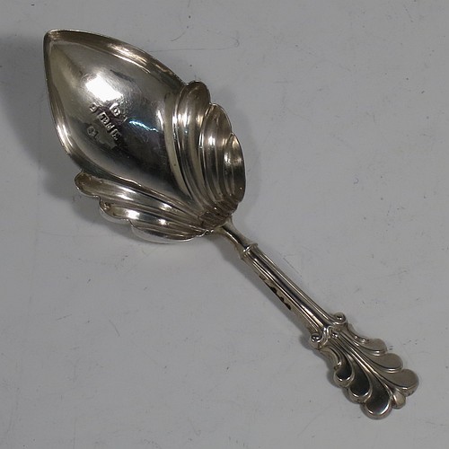 An Antique Georgian Sterling Silver tea caddy spoon, having a hand-chased handle with reeded anthemion leaf floral decoration, and a hand-chased fluted oval pointed bowl. Made by Thomas Fowke of London in 1831. The dimensions of this fine hand-made antique silver tea caddy spoon are length 10 cms (4 inches), width across bowl 3.5 cms (1.3 inches), and it weighs approx. 8g (0.25 troy ounces).
