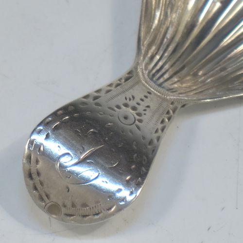 A very elegant Antique Georgian Sterling Silver tea caddy spoon, having an engraved curved handle, and a hand-chased shell style oval bowl. Made in London in 1788. The dimensions of this fine hand-made antique silver tea caddy spoon are length 7 cms (2.75 inches), width 3.5 cms (1.3 inches), and it weighs approx. 11g (0.4 troy ounces). Please note that this item is monogrammed.