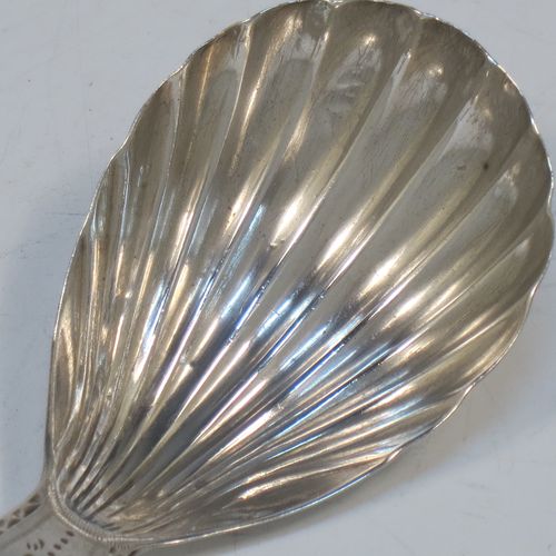 A very elegant Antique Georgian Sterling Silver tea caddy spoon, having an engraved curved handle, and a hand-chased shell style oval bowl. Made in London in 1788. The dimensions of this fine hand-made antique silver tea caddy spoon are length 7 cms (2.75 inches), width 3.5 cms (1.3 inches), and it weighs approx. 11g (0.4 troy ounces). Please note that this item is monogrammed.