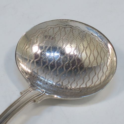 An Antique Georgian Sterling Silver tea caddy spoon, having a double-struck Fiddle, Thread, and Shell pattern handle, and a hand-engraved oval bowl with wriggle-work decoration. Made in ca. 1820 (marks rubbed). The dimensions of this fine hand-made antique silver tea caddy spoon are length 12 cms (4.75 inches), width across bowl 4.5 cms (1.75 inches), and it weighs approx. 27g (0.9 troy ounces).