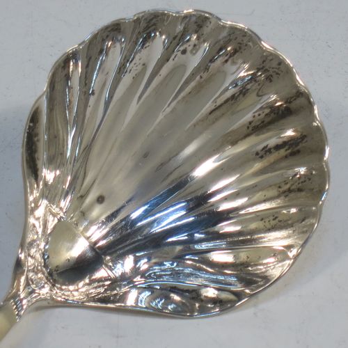 A very elegant Antique Georgian Sterling Silver tea caddy spoon, having a plain Old English pattern curved handle, and a hand-chased shell style shaped round bowl. Made by Thomas Hayter of London in 1807. The dimensions of this fine hand-made antique silver tea caddy spoon are length 8 cms (3.25 inches), width 4 cms (1.5 inches), and it weighs approx. 11g (0.4 troy ounces).