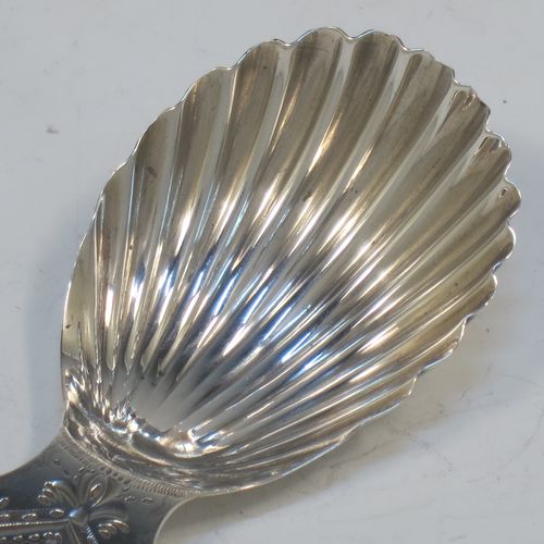 A very pretty Antique Georgian Sterling Silver tea caddy spoon, having an engraved flat handle, and a hand-chased shell style oval bowl. Made by Josiah Snatt of London in 1798. The dimensions of this fine hand-made antique silver tea caddy spoon are length 7 cms (2.75 inches), width 3.5 cms (1.3 inches), and it weighs approx. 9g (0.3 troy ounces).