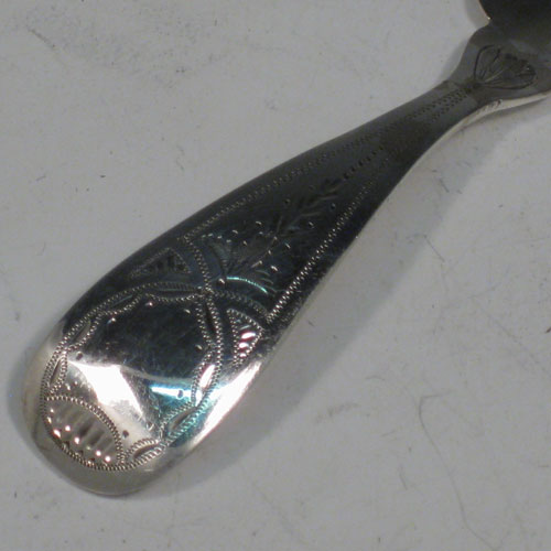 Antique Georgian sterling silver tea caddy spoon, having an engraved curved handle, and a fluted / scalloped bowl. Made by Reid and Sons of Newcastle in 1803. The dimensions of this fine hand-made silver tea caddy spoon are length 10 cms (4 inches), width 3.5 cms (1.3 inches), and it weighs approx. 14g (0.5 troy ounces).