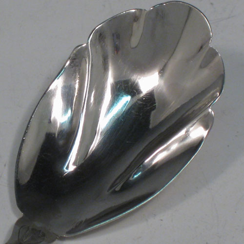 Antique Georgian sterling silver tea caddy spoon, having an engraved curved handle, and a fluted / scalloped bowl. Made by Reid and Sons of Newcastle in 1803. The dimensions of this fine hand-made silver tea caddy spoon are length 10 cms (4 inches), width 3.5 cms (1.3 inches), and it weighs approx. 14g (0.5 troy ounces).