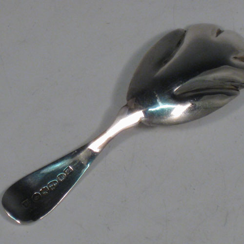 Antique Georgian sterling silver tea caddy spoon, having an engraved curved handle, and a fluted / scalloped bowl. Made by Reid and Sons of Newcastle in 1803. The dimensions of this fine hand-made silver tea caddy spoon are length 10 cms (4 inches), width 3.5 cms (1.3 inches), and it weighs approx. 14g (0.5 troy ounces).
