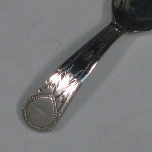 Antique Georgian sterling silver tea caddy spoon, having an engraved curved handle, and an engraved and bowl, with floral decoration. Made by Joseph Taylor of Birmingham in 1802. The dimensions of this fine hand-made silver tea caddy spoon are length 8 cms (3 inches), width 3.5 cms (1.3 inches), and it weighs approx. 6g (0.2 troy ounces).