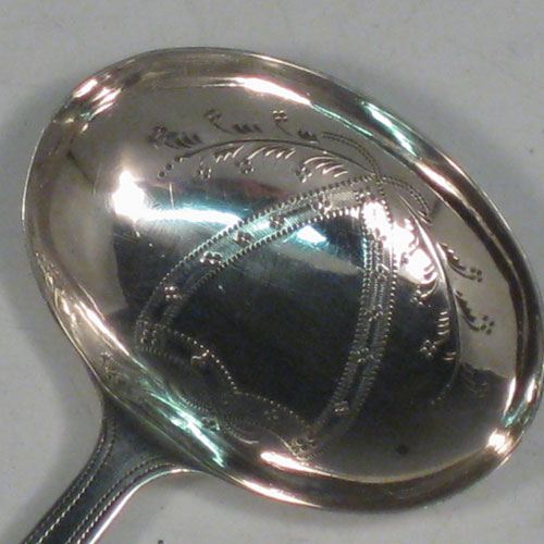 Antique Georgian sterling silver tea caddy spoon, having an engraved flat handle, and an engraved oval bowl, with floral decoration. Made by Joseph Taylor of Birmingham in 1800. The dimensions of this fine hand-made silver tea caddy spoon are length 7.5 cms (3 inches), width 4.5 cms (1.75 inches), and it weighs approx. 7g (0.2 troy ounces).