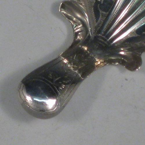 Antique Georgian sterling silver tea caddy spoon, having an engraved curved handle, and an engraved and fluted / scalloped bowl, with floral decoration. Made by John Bettridge of Birmingham in 1822. The dimensions of this fine hand-made silver tea caddy spoon are length 6.5 cms (2.5 inches), width 4 cms (1.5 inches), and it weighs approx. 6g (0.2 troy ounces).