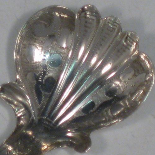 Antique Georgian sterling silver tea caddy spoon, having an engraved curved handle, and an engraved and fluted / scalloped bowl, with floral decoration. Made by John Bettridge of Birmingham in 1822. The dimensions of this fine hand-made silver tea caddy spoon are length 6.5 cms (2.5 inches), width 4 cms (1.5 inches), and it weighs approx. 6g (0.2 troy ounces).