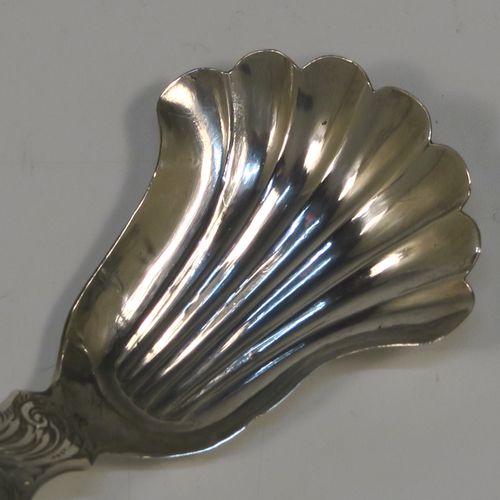 A very pretty Antique Victorian Sterling Silver tea caddy spoon, having a hand-engraved handle with floral and scroll decoration, and a hand-chased shell style bowl. This elegant antique silver tea caddy spoon was made by Thomas Danes of Birmingham in 1850. The dimensions of this fine hand-made antique silver tea caddy spoon are length 8 cms (3 inches), width 4 cms (1.5 inches), and it weighs approx. 7.5g (0.24 troy ounces).