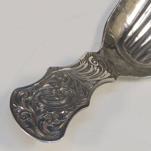 A very pretty Antique Victorian Sterling Silver tea caddy spoon, having a hand-engraved handle with floral and scroll decoration, and a hand-chased shell style bowl. This elegant antique silver tea caddy spoon was made by Thomas Danes of Birmingham in 1850. The dimensions of this fine hand-made antique silver tea caddy spoon are length 8 cms (3 inches), width 4 cms (1.5 inches), and it weighs approx. 7.5g (0.24 troy ounces).