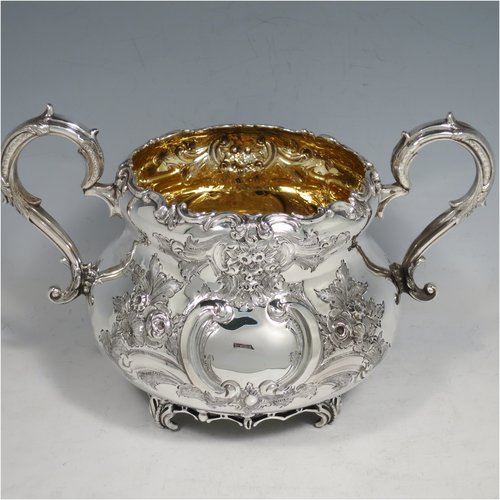 An Antique Victorian Sterling Silver four-piece tea and coffee set, having round baluster bodies with hand-chased floral decoration, with silver insulated handles, cast eagle finials, eagle face spouts, the sugar bowl and cream jug with gold-gilt interiors, and all sitting on cast and hand-pierced feet. All made by Martin & Hall, with the teapot & cream jug from London in 1870, the coffee pot from Sheffield in 1890, and the sugar bowl from Sheffield in 1896. The dimensions of this fine hand-made silver tea and coffee service are length of teapot 27 cms (10.6 inches), height of coffee pot 26 cms (10.25 inches), and the total weight is approx. 2,253g (73 troy ounces).