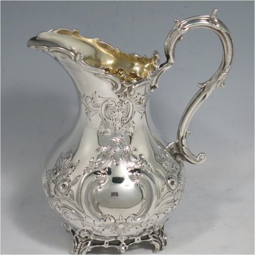 An Antique Victorian Sterling Silver four-piece tea and coffee set, having round baluster bodies with hand-chased floral decoration, with silver insulated handles, cast eagle finials, eagle face spouts, the sugar bowl and cream jug with gold-gilt interiors, and all sitting on cast and hand-pierced feet. All made by Martin & Hall, with the teapot & cream jug from London in 1870, the coffee pot from Sheffield in 1890, and the sugar bowl from Sheffield in 1896. The dimensions of this fine hand-made silver tea and coffee service are length of teapot 27 cms (10.6 inches), height of coffee pot 26 cms (10.25 inches), and the total weight is approx. 2,253g (73 troy ounces).
