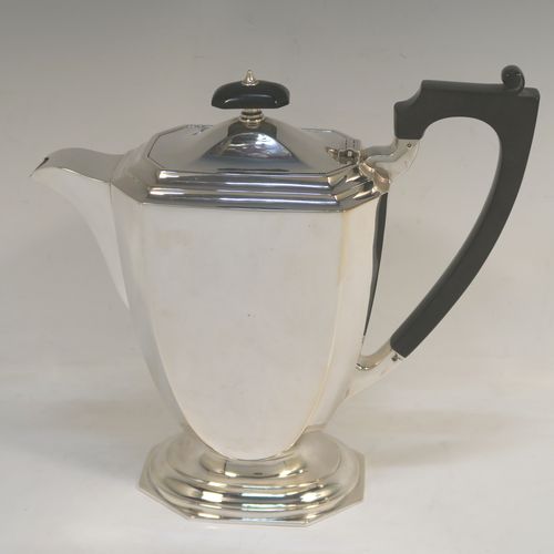 A very handsome and stylish Sterling Silver Art Deco style four-piece tea and coffee service, having plain octagonal bodies with tapering sides, with black stained wooden handles and finials, and sitting on plain stepped pedestal feet. This elegant silver tea and coffee set was made by the Barker Brothers of Birmingham in 1937. The dimensions of this fine hand-made Art Deco style tea and coffee service are length of teapot 31 cms (12.25 inches), height of coffee pot 21 cms (8.25 inches), and the total weight is approx. 1,874g (60 troy ounces).