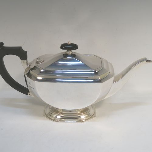 A very handsome and stylish Sterling Silver Art Deco style four-piece tea and coffee service, having plain octagonal bodies with tapering sides, with black stained wooden handles and finials, and sitting on plain stepped pedestal feet. This elegant silver tea and coffee set was made by the Barker Brothers of Birmingham in 1937. The dimensions of this fine hand-made Art Deco style tea and coffee service are length of teapot 31 cms (12.25 inches), height of coffee pot 21 cms (8.25 inches), and the total weight is approx. 1,874g (60 troy ounces).