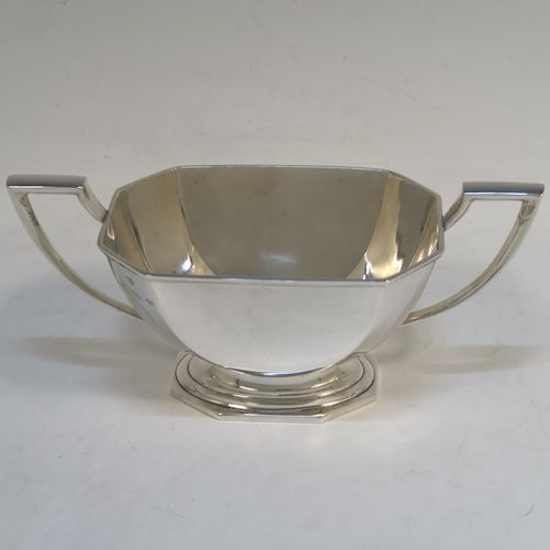 A very handsome and stylish Sterling Silver Art Deco style four-piece tea and coffee service, having plain octagonal bodies with tapering sides, with black stained wooden handles and finials, and sitting on plain stepped pedestal feet. This elegant silver tea and coffee set was made by the Barker Brothers of Birmingham in 1937. The dimensions of this fine hand-made Art Deco style tea and coffee service are length of teapot 31 cms (12.25 inches), height of coffee pot 21 cms (8.25 inches), and the total weight is approx. 1,874g (60 troy ounces).