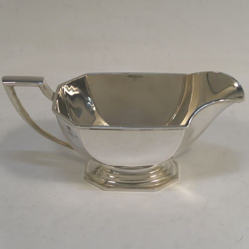 A very handsome and stylish Sterling Silver Art Deco style four-piece tea and coffee service, having plain octagonal bodies with tapering sides, with black stained wooden handles and finials, and sitting on plain stepped pedestal feet. This elegant silver tea and coffee set was made by the Barker Brothers of Birmingham in 1937. The dimensions of this fine hand-made Art Deco style tea and coffee service are length of teapot 31 cms (12.25 inches), height of coffee pot 21 cms (8.25 inches), and the total weight is approx. 1,874g (60 troy ounces).