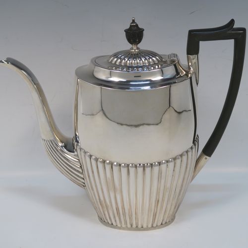 A very handsome Antique Victorian Sterling Silver Queen Anne style four-piece tea and coffee set consisting of a coffee pot, tea-pot, sugar bowl, and milk / cream jug, having oval bodies with hand-chased half-fluted decoration and applied reeded borders, with wooden handles and finials, and all sitting on collet feet. All made by James Dixon and Sons of Sheffield in 1894. The dimensions of this fine hand-made antique silver tea and coffee service are length of teapot 25.5 cms (10 inches), height of coffee pot 23.5 cms (9.25 inches), and the total weight is approx. 1,500g (48 troy ounces).  